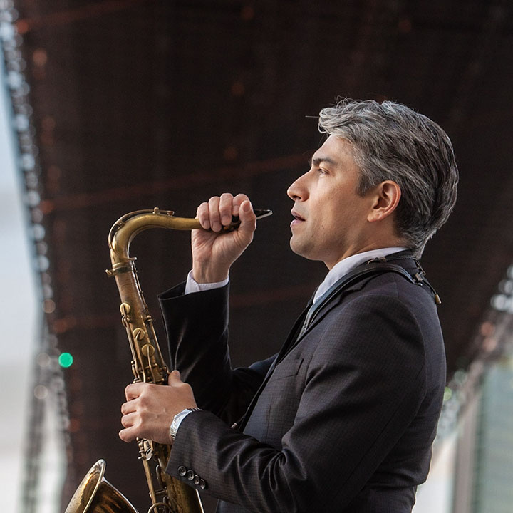 man in suit holding a sax